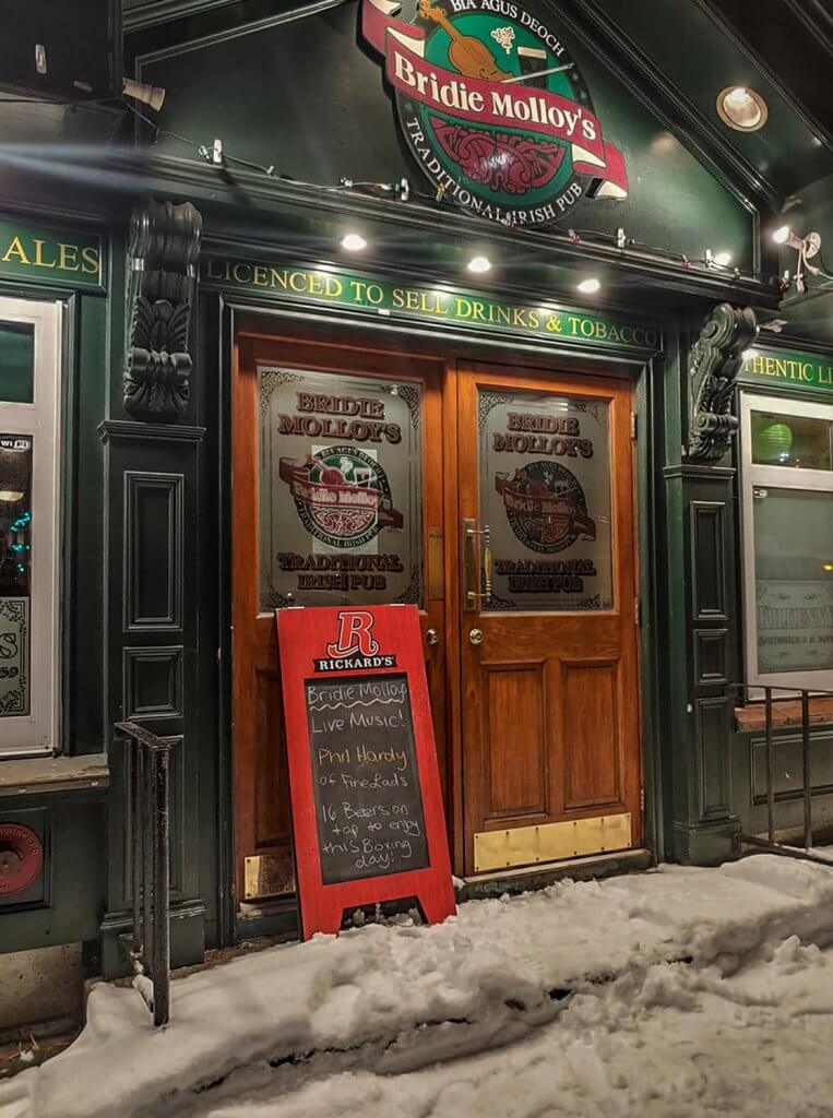 The outside of Bridie Molloy's, looking cheerful and welcoming on a winter's evening.