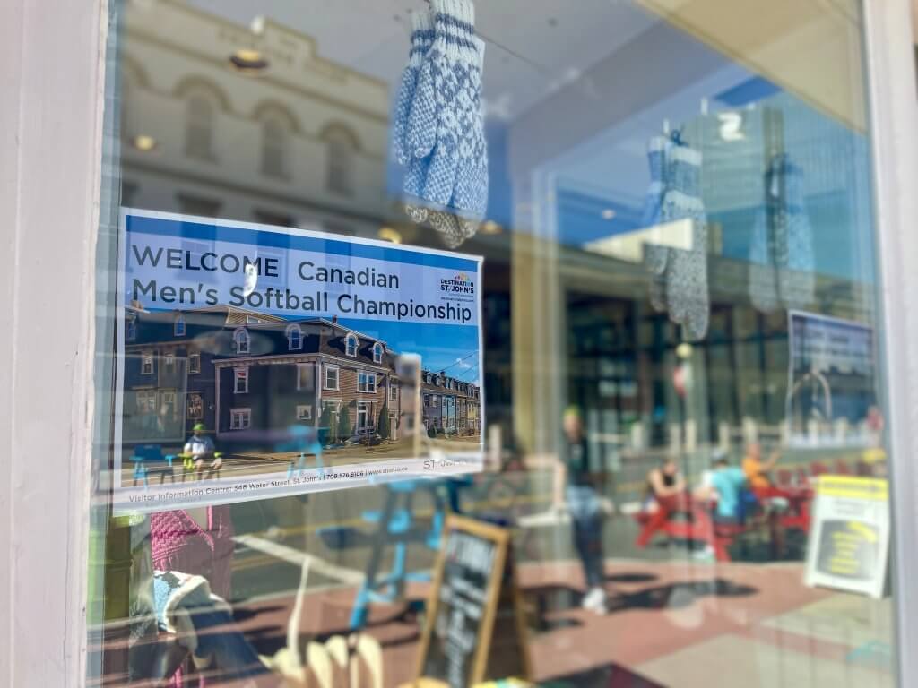Welcome poster is shown in the window of NONIA on Water Street in downtown St. John's, NL